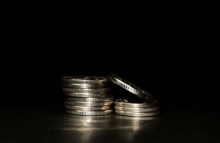 silver coin stack isolated on black background with reflection. Space for textの写真素材