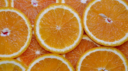 Abstract background with citrus fruit of orange slices. Close up. Studio photography.の写真素材