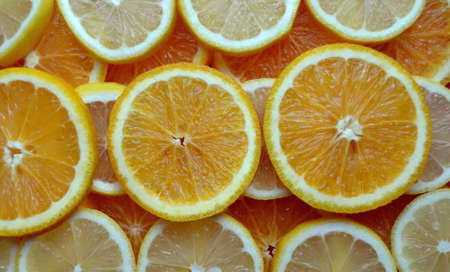 Abstract background with citrus fruit of orange and lemon slices. Close up. Studio photography.の写真素材