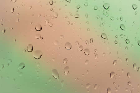 Abstract of colored drops on the glass with colored backgroundの写真素材