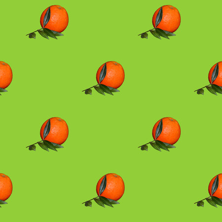 Pattern of Fresh orange citrus fruit with leaves isolated on green background.