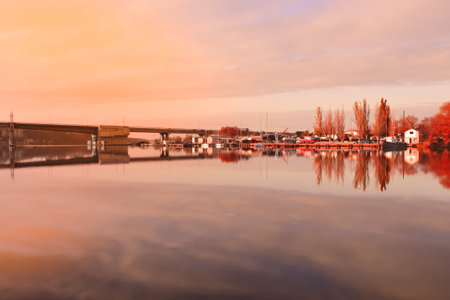 Autumn reflections at the river. Beautiful landscape at sunset