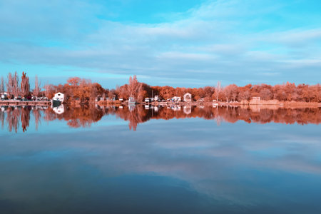 Autumn reflections at the river. Concept photo of the coming of autumn. Beautiful landscape with...