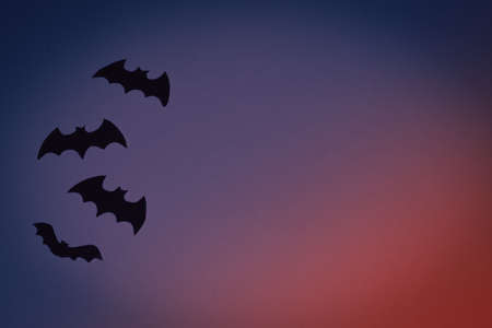 Little black toys bats on dark blue background. Halloween conceptの写真素材