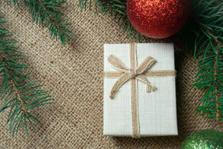 Christmas holidays composition with white gift box and coniferous tree branch. Happy New Year and Merry Christmas conceptの写真素材