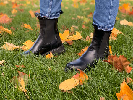 Autumn shoes in the fall foliage. Leaf fall. Autumn walks through fallen leavesの写真素材
