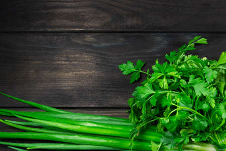 Fresh garden herbs on dark wooden background with space for text. Top view. Concept of healthy, vegetarian, diet food.の写真素材