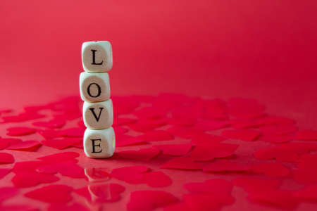 Wooden cubes with the words LOVE on red background. Valentine's day conceptの写真素材