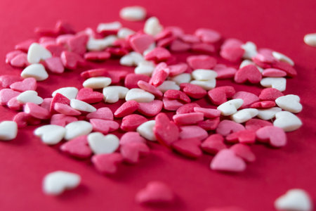Heart shape candy for Valentine's day on red background