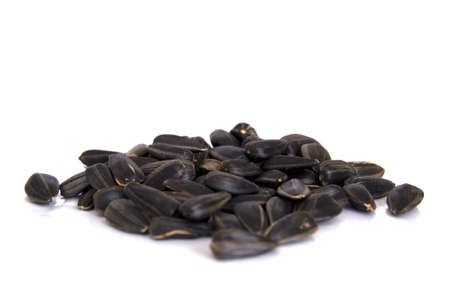 Sunflower seeds isolated on white background. Close up photo of black sunflower seeds.の写真素材