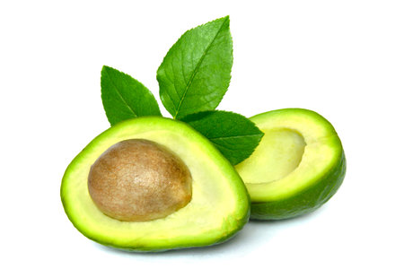 Green avocado with leaves isolated on a white background.