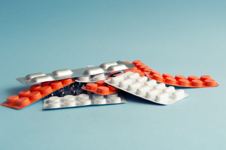 Heap of pills on blue background. Space for your text