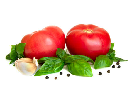 Tomato, basil leaves, garlic cloves isolated on a white background as package design elementの写真素材