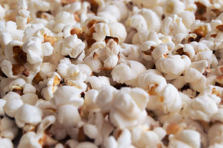 Heap of delicious popcorn isolated on a white background. Scattered popcorn texture background. selective focus.の写真素材