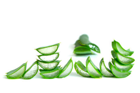 heap of aloe vera fresh sliced leaves isolated over white backgroundの写真素材