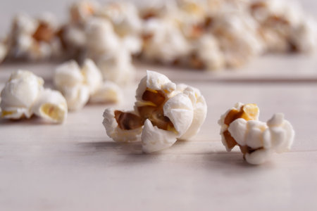 Popcorn on a white wooden table, close upの写真素材