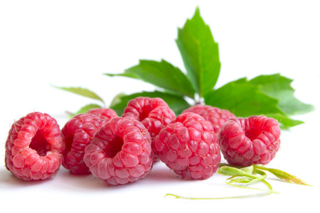 Isolated berries. Pile of raspberry fruits with leaves isolated on a white background with clipping pathの写真素材