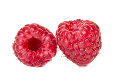 Isolated ripe berries. Two fresh raspberries isolated on white backgroundの写真素材