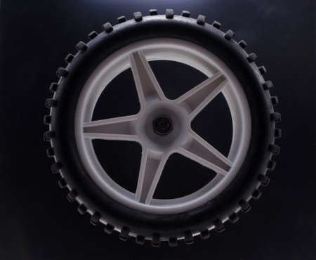 Baby car wheel on a black background close-upの写真素材