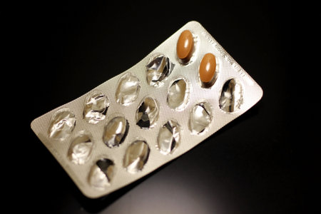 Pills in a blister pack on a black background