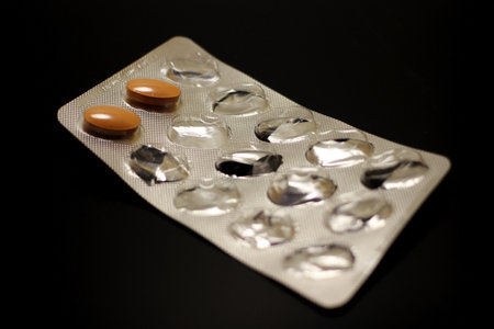 Pills in a blister pack on a black backgroundの写真素材