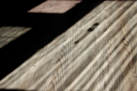 Wooden floor with shadow and sunlight on it