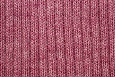 Abstract pink knitted fabric texture closeup