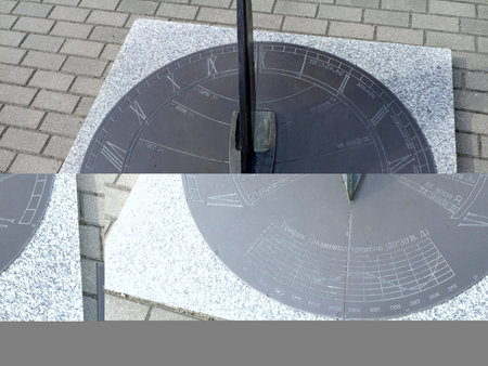 a sundial set into a paved sidewalkの写真素材
