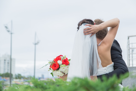 Happy young couple in love. The bride and groom walk. The couple stand and look into the distance. Wedding day.の写真素材