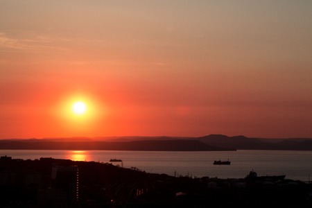 Red, beautiful colorful sunset, sunrise on the sea. Dramatic story with ships on the sea sunの写真素材