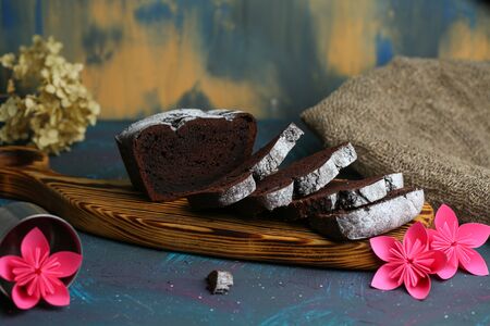 Sliced chocolate muffin lies on a cutting board. Background.の写真素材