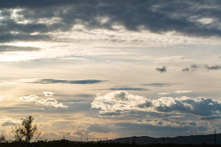 Picturesque landscape, beautiful sky with clouds. In the distance there is a road with city...