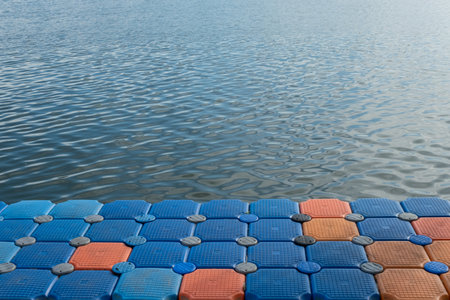 Floating pier made of composite plastic blocks on the river, sea. Plastic bridge on a lake.の写真素材