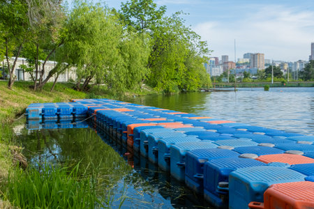 Floating pier made of composite plastic blocks on the river, sea. Plastic bridge on a lake.の写真素材