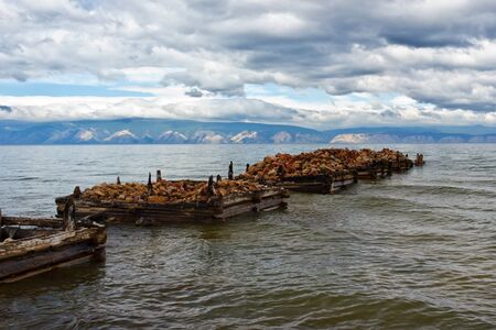 The destroyed jetty on the bank of island Olkhon on lake Baikalの写真素材