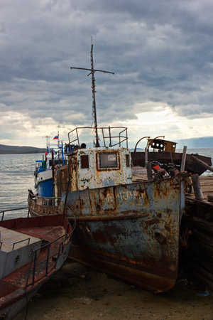 The old ship is moored inshore lakes Baikal about settlement Huzhir on island Olkhonのeditorial素材