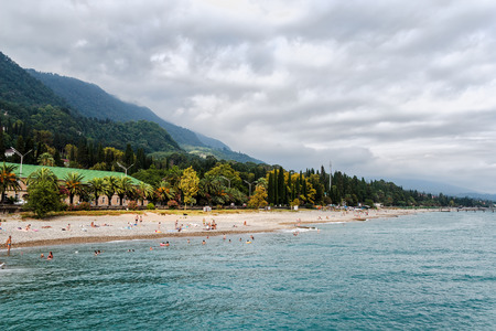 Beach on city embankment New Athos in republic Abkhazia - the most accessible beach on Black seaの写真素材