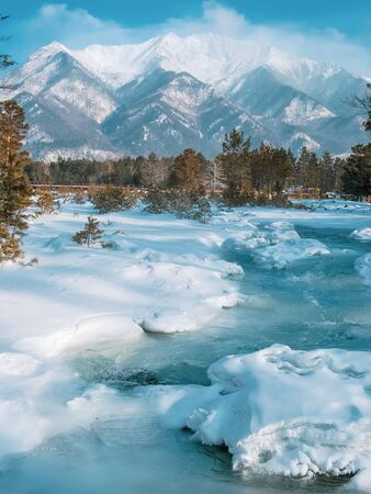 colorful view of the snow-white mountain and the river, winter backgroundの写真素材