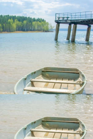 old wooden boat on the beach by the river on a sunny summer day,