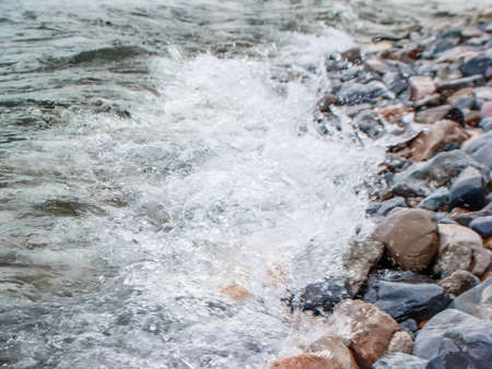 Background of Water in a raging mountain river. Beautiful natural background of stones and water. The texture of clear water and a fast river..の写真素材