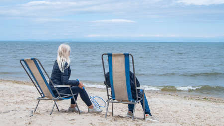 two people on the beach in autumn.の写真素材