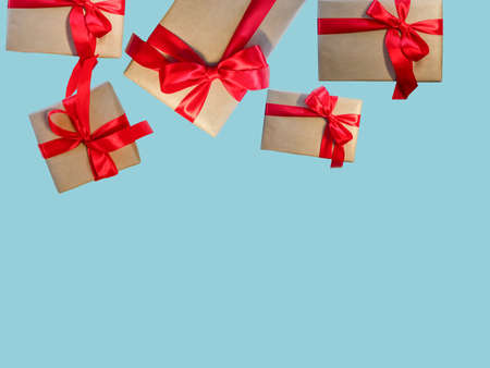 Gift boxes with red ribbon, copy space on a light blue background. Sales concepts, discount price, Christmas gifts and shopping, Greeting card for Christmas, Valentine's Day or New Year.の写真素材