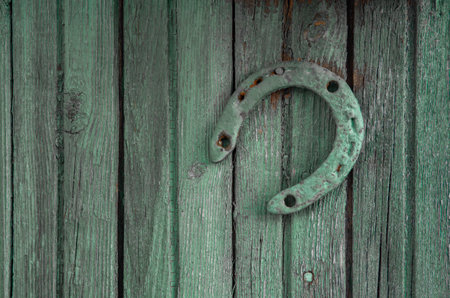 Horseshoe on vintage wooden board.の写真素材