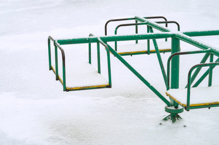 Children's carousel under the white snow.