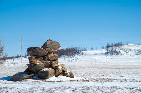 Zen concept. A pyramid made of stone on top of a mountain Stone pyramid for meditation. Harmony and Meditation. Zen stonesの写真素材