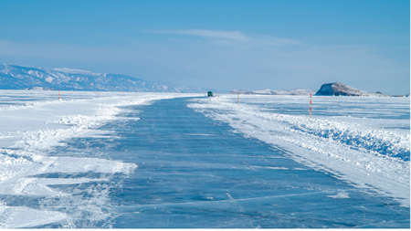 Ice surface of Baikal. Ice road along which in winter you can get by car from the mainland to Olkhon Island on Lake Baikalの写真素材