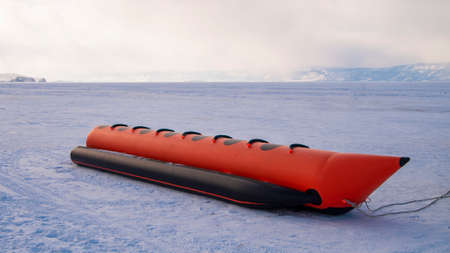 Outdoor activities, Riding a banana on a frozen lake.の写真素材