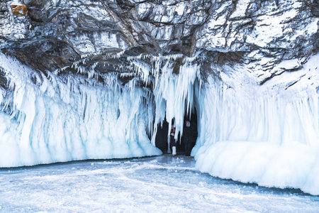 Tourists in a grotto on the winter coast of Lake Baikal.