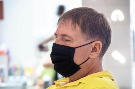 A man in a medical mask. Protection against viruses, bacteria, diseases. Portrait of an elderly man