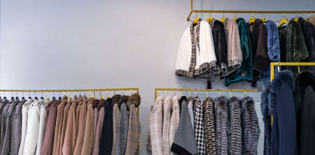 Spring womens coats hanging on a rack in a womens clothing storeの写真素材